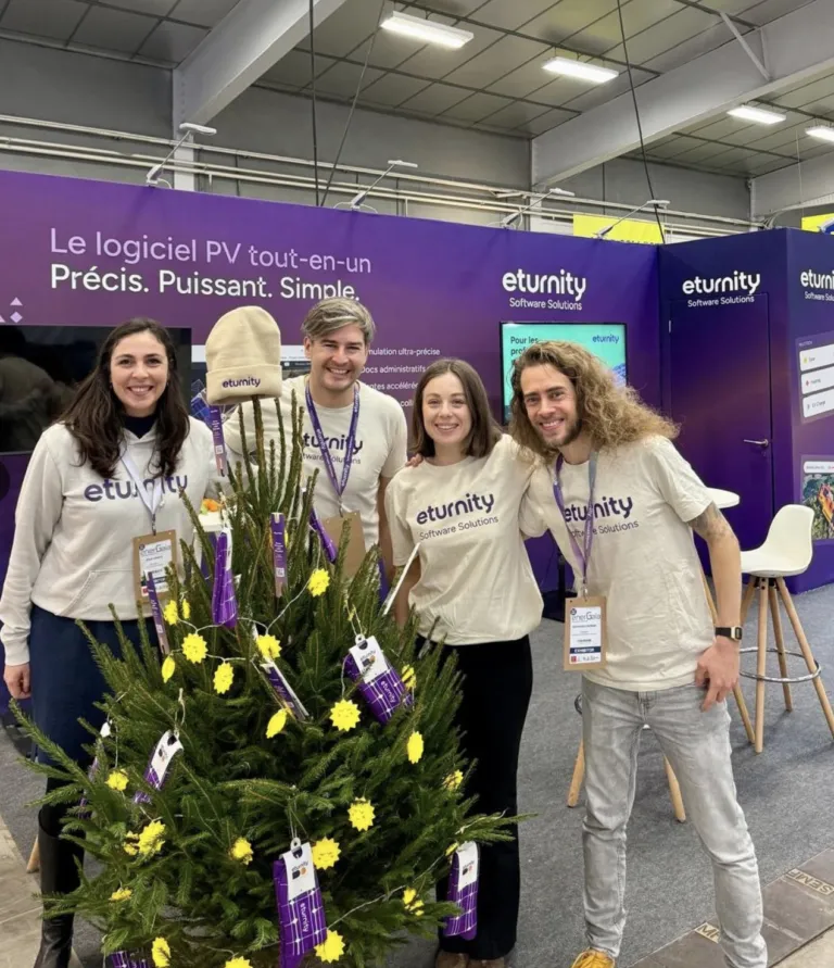 Four Eturnity team members in branded shirts at their booth at the Energaia trade fair
